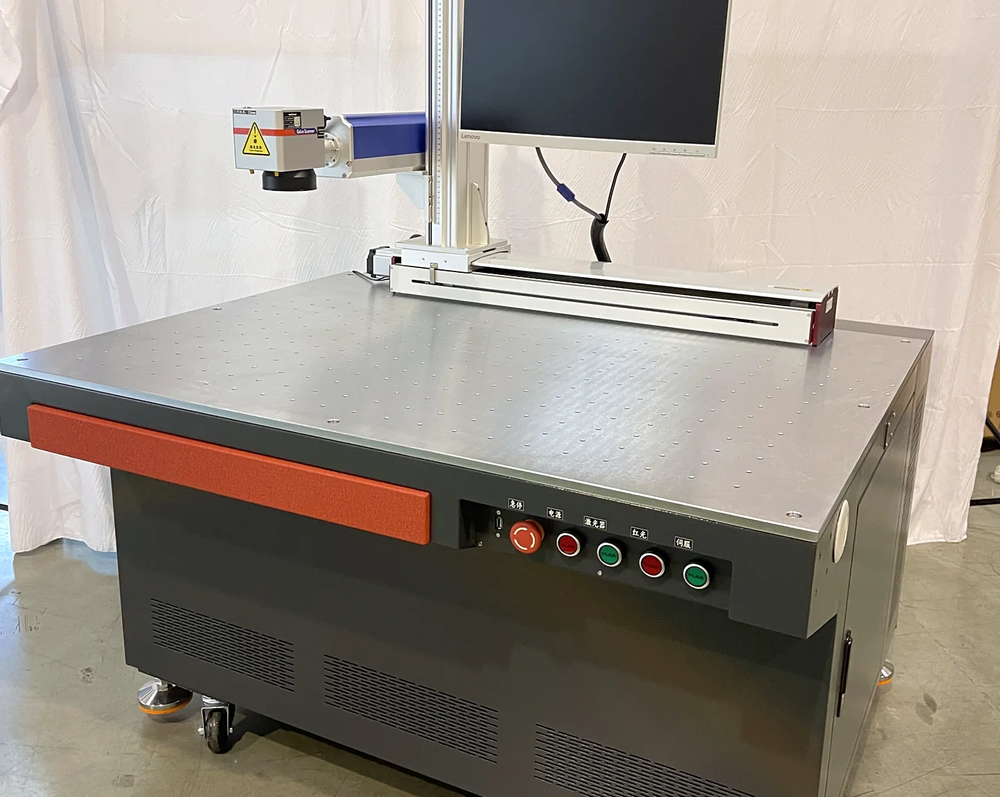 Large-format Laserhi fiber laser marking machine with its flat work table, galvo head and operator button panel