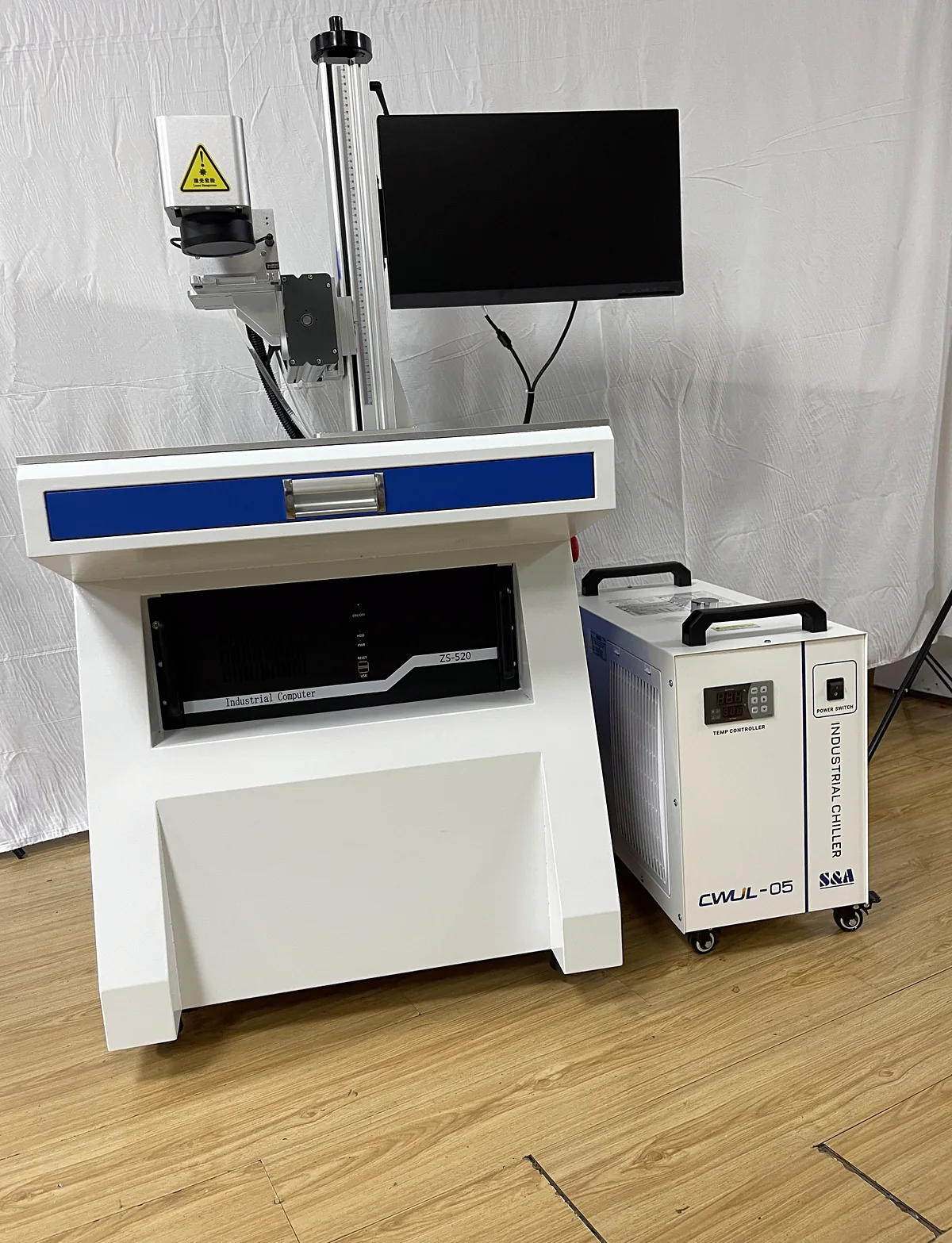 Front view of the Laserhi UV laser marking machine showing monitor arm and industrial computer